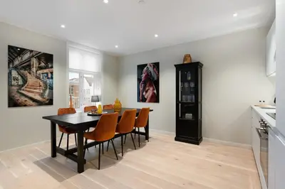 a kitchen and dining room with a table and chairs at Keyser Apartments 6 in Bergen