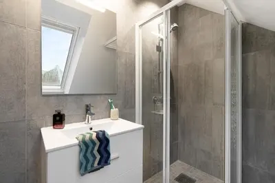 a bathroom with a sink and a shower at Keyser Apartments 6 in Bergen