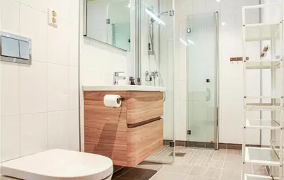 a bathroom with a shower and a toilet and a sink at Privat'n in Hemsedal