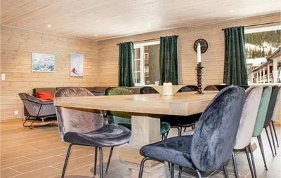 a dining room with a wooden table and chairs at Privat'n in Hemsedal