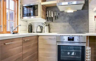 a kitchen with a stove and a sink at Privat'n in Hemsedal