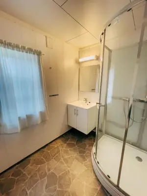 a bathroom with a shower and a sink at Ryen Hytteutleie - Cottages in Røros