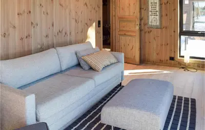 a blue couch and a stool in a living room at Amazing Home In Flå With Wifi in Flå