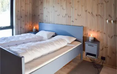 a bed with two white pillows on it in a room at Amazing Home In Flå With Wifi in Flå