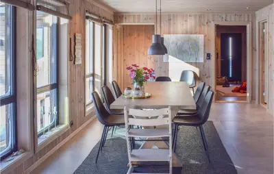 a dining room with a wooden table and chairs at Amazing Home In Flå With Wifi in Flå