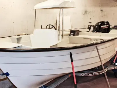 a white boat sitting in a room at 6 person holiday home in VATNE in Vatne