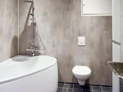 a bathroom with a white toilet and a sink at 8 person holiday home in VATNE in Vatne