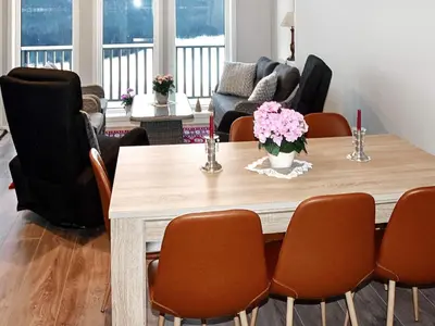 a dining room with a table and chairs at 8 person holiday home in VATNE in Vatne