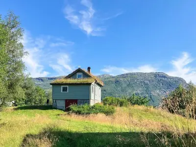 an old house with a grass roof on a hill at Secluded Mountain Retreat-By Traum in Vassenden