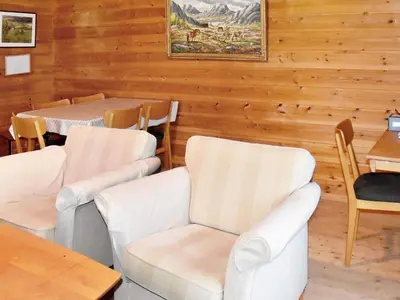 a dining room with white chairs and a table at Secluded Mountain Retreat-By Traum in Vassenden