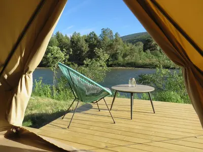 a tent with a table and a chair on a deck at Toftemo Turiststasjon in Dovre