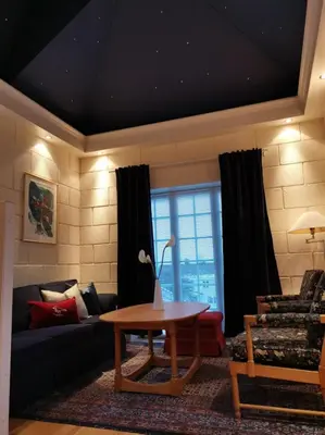 a living room with a couch and a table at Sanner Hotell in Gran