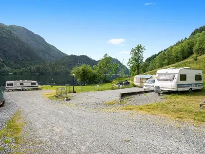 a group of rvs parked next to a lake at Grimen Camping in Bergen
