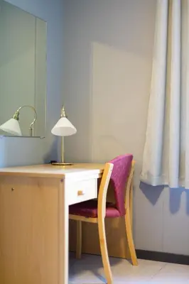 a desk with a lamp and a purple chair at Havly Bed & Breakfast in Hauge