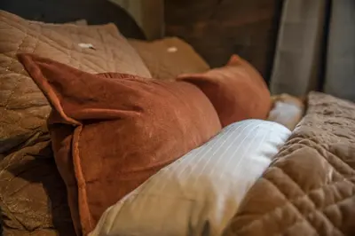 a dog laying on a bed with a tie on it at Fjelleventyret gårdsovernatting in Skjåk