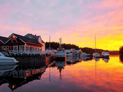 a group of boats docked at a marina at sunset at 6 person holiday home in Austrheim in Utkeila