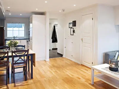 a kitchen and living room with a table and a dining room at 6 person holiday home in Austrheim in Utkeila