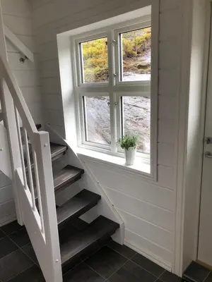 a staircase in a house with a window at Tunold Gård - Freden in Stryn