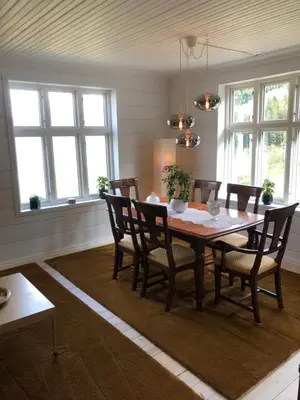 a dining room with a wooden table and chairs at Tunold Gård - Freden in Stryn