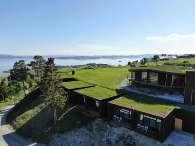 an aerial view of a house with a green roof at Øyna Kulturlandskapshotell in Straumen
