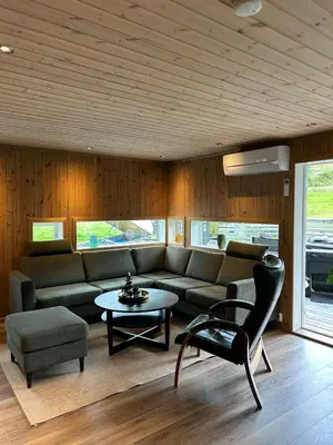 a living room with a couch and a table at Tuddal Hyttegrend HYTTA KÅNS in Tuddal