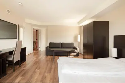 a hotel room with a bed and a desk at Aursnes Hotell in Sykkylven