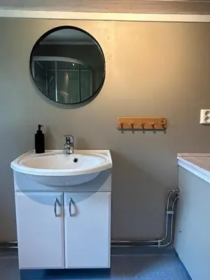a bathroom with a sink and a mirror on the wall at Harekroken in Tynset