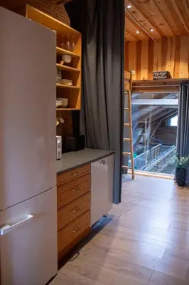 a kitchen with a refrigerator and a counter top at Unik fjøsleilighet in Levanger