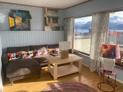 a living room with a couch and a table at EIDE Gjestehus in Eide