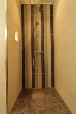 a bathroom with a shower with a shower head at Olden Panorama Apartments - Fjord view - High Standard in Olden