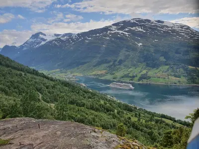 a large body of water in front of a mountain at Olden Panorama Apartments - Fjord view - High Standard in Olden