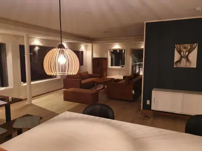 a living room with a couch and a table at Olden Panorama Apartments - Fjord view - High Standard in Olden
