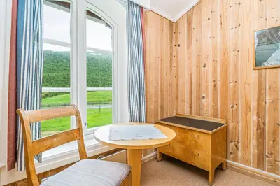 a room with a desk and a chair and a window at Kongsvold Fjeldstue by Frich`s in Oppdal