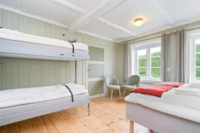 two bunk beds in a room with wooden floors at Kongsvold Fjeldstue by Frich`s in Oppdal