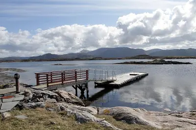 a dock in the middle of a body of water at Korsholmen - by Classic Norway Hotels in Karvåg