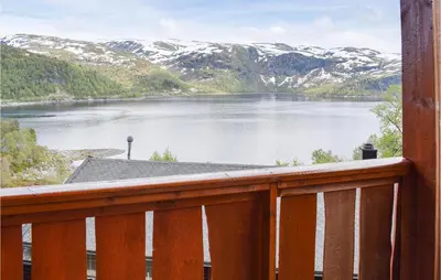 a view of a lake with snow covered mountains at Stordalen in Bjordal