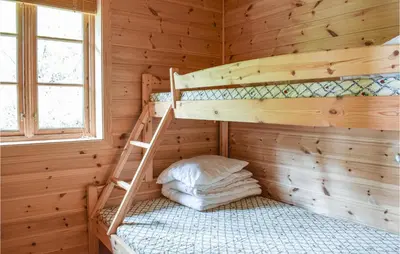 a room with two bunk beds in a wooden cabin at Stordalen in Bjordal