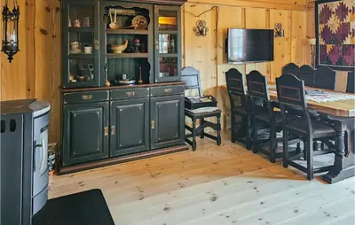 a kitchen with a counter and a table and chairs at 3 Bedroom Lovely Home In Nordberg in Skjåk