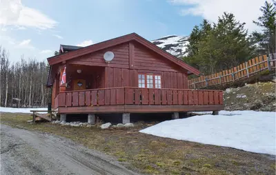 a large wooden cabin with snow on the ground at 3 Bedroom Lovely Home In Nordberg in Skjåk