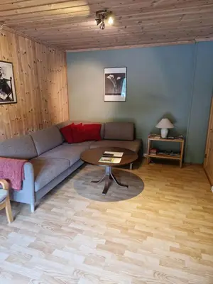 a living room with a couch and a table at Kvamsdal Pensjonat in Eidfjord