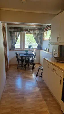 a kitchen and dining room with a table and chairs at Kvamsdal Pensjonat in Eidfjord