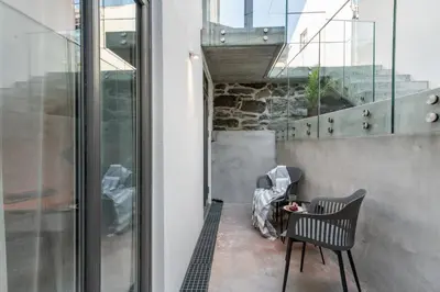 a balcony with a chair and a table at Aalesund City Apartment in Ålesund