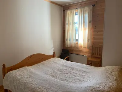 a bedroom with a white bed and a window at Norefri apartment with sauna at Nedre Norefjell Ski In- Ski Out in Noresund