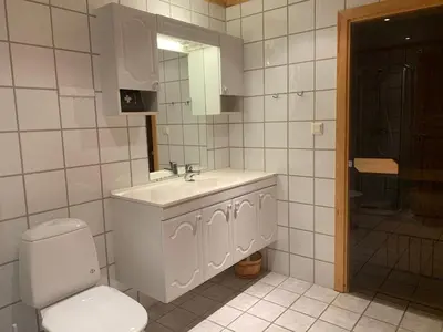 a white bathroom with a sink and a toilet at Norefri apartment with sauna at Nedre Norefjell Ski In- Ski Out in Noresund