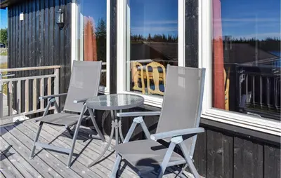 two chairs and a table on a porch at Leil Nr 32 in Sjusjøen