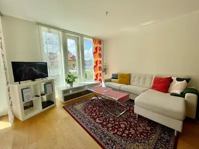 a living room with a couch and a tv at Cityfjord apartment in Bergen centrum in Bergen