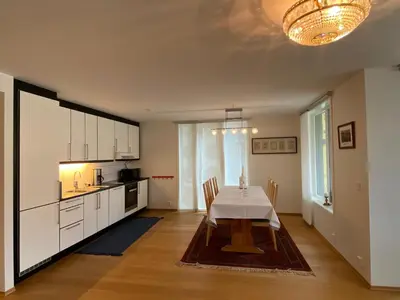 a kitchen with a table and a dining room at Cityfjord apartment in Bergen centrum in Bergen