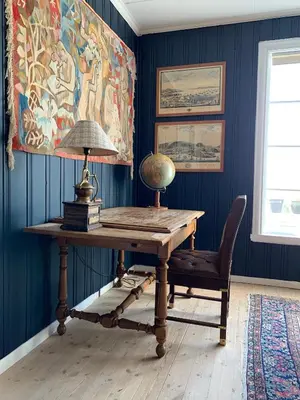 a desk with a lamp and a chair in a room at Moldegaard Farmhouse - Apartment A in Moldegard