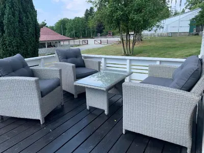a group of chairs and a table on a deck at Moldegaard Farmhouse - Apartment A in Moldegard