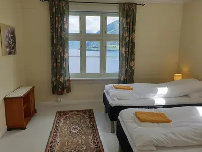 a room with two beds and a window at Irenegarden - Fjord view holiday home in Lauvstad